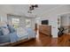 Bright main bedroom with hardwood floors, paneled walls, and tray ceiling at 10513 Cardington Ln, Raleigh, NC 27614