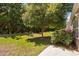 Backyard featuring a well-maintained lawn, mature tree, mature shrubs, and concrete patio at 112 Sabiston Ct, Cary, NC 27519