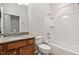 Functional bathroom featuring a granite countertop, wood cabinet, toilet, and bathtub with a shower at 112 Sabiston Ct, Cary, NC 27519