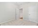Neutral bedroom featuring plush carpeting and two doors adding function and flow to the space at 112 Sabiston Ct, Cary, NC 27519