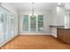 Bright dining area with wood floors, plantation shutters, and a modern chandelier at 112 Sabiston Ct, Cary, NC 27519