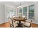 Dining area with a round table, wood floors, plantation shutters and large windows at 112 Sabiston Ct, Cary, NC 27519