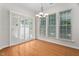 Dining area featuring wood floors, shuttered door and multiple windows for natural light at 112 Sabiston Ct, Cary, NC 27519
