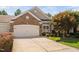 A well-maintained home features a brick facade and lush green landscaping at 112 Sabiston Ct, Cary, NC 27519