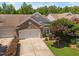 Charming brick home featuring an attached two-car garage, tidy landscaping, and a manicured lawn at 112 Sabiston Ct, Cary, NC 27519