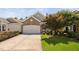 Beautiful home with a two-car garage, attractive landscaping, and a paved driveway at 112 Sabiston Ct, Cary, NC 27519