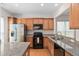 Updated kitchen with stainless steel appliances, granite countertops and light wood cabinetry at 112 Sabiston Ct, Cary, NC 27519