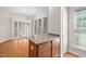 Eat-in kitchen with a granite countertop island, chandelier lighting and wood floors at 112 Sabiston Ct, Cary, NC 27519