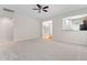 Spacious open-concept living area featuring carpet, ceiling fan, and seamless flow to adjacent rooms at 112 Sabiston Ct, Cary, NC 27519
