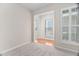 Bright living room with neutral carpet, archways, plantation shutters, and plenty of natural light at 112 Sabiston Ct, Cary, NC 27519