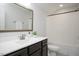 Bathroom featuring dark wood vanity, soft lighting, and framed mirror; adding a touch of elegance at 1125 Russet Ln, Apex, NC 27523