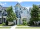 Charming two-story home featuring a unique turret design and colorful accents on a manicured lawn at 1125 Russet Ln, Apex, NC 27523