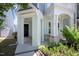 Inviting front porch with elegant columns, a peaceful entry, and manicured landscaping at 1125 Russet Ln, Apex, NC 27523