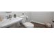 Modern half bathroom featuring a stylish sink and fixtures, with wood-look flooring at 1125 Russet Ln, Apex, NC 27523