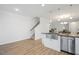 Bright kitchen with stainless steel sink, island, and view of dining area and staircase at 1125 Russet Ln, Apex, NC 27523
