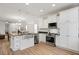 Spacious open kitchen with stainless steel appliances, granite counters and view of dining and living area at 1125 Russet Ln, Apex, NC 27523