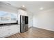 Bright, airy kitchen showcasing granite countertops, white cabinets, and stainless-steel refrigerator at 1125 Russet Ln, Apex, NC 27523