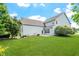 Expansive backyard with lush green lawn and a view of the home's exterior at 1148 Survada Ln, Morrisville, NC 27560