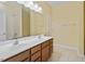Bathroom featuring a double vanity, framed mirror, and tiled floors at 1148 Survada Ln, Morrisville, NC 27560