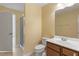 Bright bathroom with a shower, white fixtures, vanity with wooden cabinets, and tiled flooring at 1148 Survada Ln, Morrisville, NC 27560