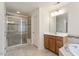 Bathroom showcasing a glass enclosed shower, soaking tub, and vanity with wood cabinets at 1148 Survada Ln, Morrisville, NC 27560