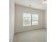 Carpeted bedroom with two bright windows at 1148 Survada Ln, Morrisville, NC 27560