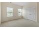 Bright bedroom with two windows, neutral carpet, and a double-door closet at 1148 Survada Ln, Morrisville, NC 27560