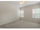 Bright bedroom features neutral colors, plush carpet, and natural light from two windows at 1148 Survada Ln, Morrisville, NC 27560