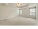 Spacious bedroom features a tray ceiling, ceiling fan, and windows with natural light at 1148 Survada Ln, Morrisville, NC 27560