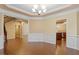 Spacious dining room featuring hardwood flooring, wainscoting and access to the staircase at 1148 Survada Ln, Morrisville, NC 27560