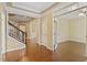 Elegant entryway with hardwood floors, staircase, and view into the adjoining rooms at 1148 Survada Ln, Morrisville, NC 27560