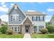Charming two-story home with a beautifully landscaped yard and a mix of stone and siding facade at 1148 Survada Ln, Morrisville, NC 27560