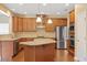 Well-lit kitchen with stainless steel appliances, granite countertops, and wooden cabinetry at 1148 Survada Ln, Morrisville, NC 27560