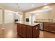 Kitchen island featuring granite countertops, wooden cabinets, and stainless steel dishwasher at 1148 Survada Ln, Morrisville, NC 27560