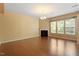Comfortable living room featuring a fireplace, hardwood flooring, and large windows at 1148 Survada Ln, Morrisville, NC 27560