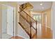 Wooden staircase with carpet runner and decorative iron railing leading to the upper level at 1148 Survada Ln, Morrisville, NC 27560