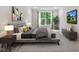 Stylishly furnished bedroom with a large window, modern art, and sleek furniture creates a tranquil living space at 11548 Helmond Way # 104, Raleigh, NC 27617