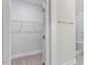 Walk-in closet with wire shelving next to a marble tiled shower offering space and practical storage at 11548 Helmond Way # 104, Raleigh, NC 27617