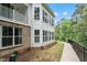 Exterior shot of a bright home featuring white siding and multiple windows, with a walkway at 11548 Helmond Way # 104, Raleigh, NC 27617