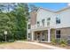 Charming two-story exterior showing a combination of brick and white siding with a quaint balcony and well-maintained landscaping at 11548 Helmond Way # 104, Raleigh, NC 27617