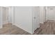 Hallway featuring modern wood-look flooring with views of other rooms adding depth and warmth at 11548 Helmond Way # 104, Raleigh, NC 27617