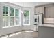Bright kitchen with stainless steel appliances and abundant natural light from large windows overlooking lush greenery at 11548 Helmond Way # 104, Raleigh, NC 27617