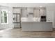 Modern kitchen with stainless steel appliances, light grey cabinetry, and a stylish island, perfect for cooking and entertaining at 11548 Helmond Way # 104, Raleigh, NC 27617