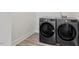 This laundry room features side-by-side, front-load washing machine and dryer at 11548 Helmond Way # 104, Raleigh, NC 27617