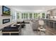 Well-decorated open-concept living room and kitchen with hardwood floors and large windows offering ample natural light at 11548 Helmond Way # 104, Raleigh, NC 27617