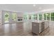 Bright, open-concept living room and kitchen with luxury vinyl plank flooring and large windows offering ample natural light at 11548 Helmond Way # 104, Raleigh, NC 27617