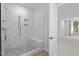 Modern shower with marble-look tile, glass enclosure, and built-in bench offers a luxurious bathing experience at 11548 Helmond Way # 104, Raleigh, NC 27617