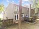 Backyard featuring a deck, wooden fence, and mature trees at 120 E Laurenbrook Ct, Cary, NC 27518