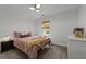 Bedroom with plush carpet, bright walls, and a window for natural light at 120 E Laurenbrook Ct, Cary, NC 27518