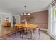 Inviting dining room with hardwood floors, modern lighting, and lots of natural light at 120 E Laurenbrook Ct, Cary, NC 27518